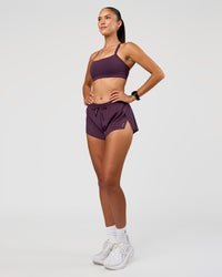 Woman wearing Accelerate 3" Mid-Rise Running Short - Midnight Plum | Model:Rhiley | Size:S