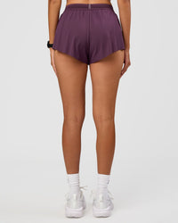 Woman wearing Accelerate 3" Mid-Rise Running Short - Midnight Plum | Set:true | Angle:back | Model:Rhiley | Size:S