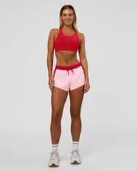 Woman wearing Accelerate 3" Mid-Rise Running Short - Scarlet-Marshmallow | Model:Amity | Size:S
