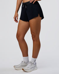 Woman wearing Accelerate 3" Pleated Mid-Rise Running Short - Black | Model:Emelia | Size:S
