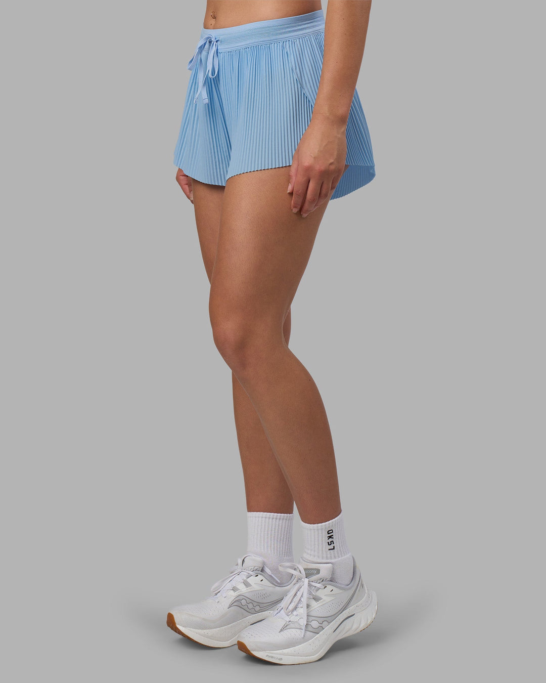 Woman wearing Accelerate 3" Pleated Running Short - Open Air | Model:Charlize | Size:S
