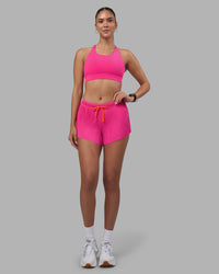 Woman wearing Accelerate 3" Pleated Running Short - Ultra Pink | Model:Rhiley | Size:S