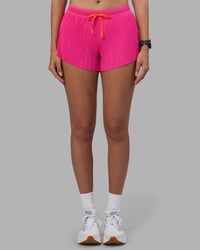 Woman wearing Accelerate 3" Pleated Running Short - Ultra Pink | Model:Rhiley | Size:S