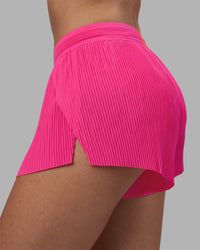 Woman wearing Accelerate 3" Pleated Running Short - Ultra Pink | Model:Rhiley | Size:S