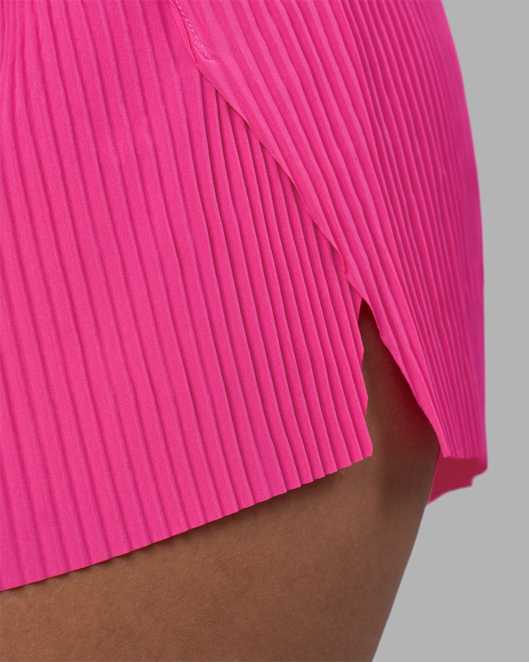 Woman wearing Accelerate 3&quot; Pleated Running Short - Ultra Pink | Model:Rhiley | Size:S