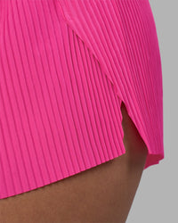 Woman wearing Accelerate 3" Pleated Running Short - Ultra Pink | Model:Rhiley | Size:S