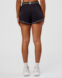 Woman wearing Accelerate 3" Reflective High-Rise Running Short - Black-Reflective | Set:true | Angle:back | Model:Rosie | Size:S