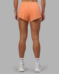 Woman wearing Accelerate 3" Running Short - Cantaloupe  | Set:true | Angle:back | Model:Hannah | Size:S