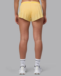 Woman wearing Accelerate 3" Running Short - Lemon | Set:true | Angle:back | Model:Sophie | Size:S
