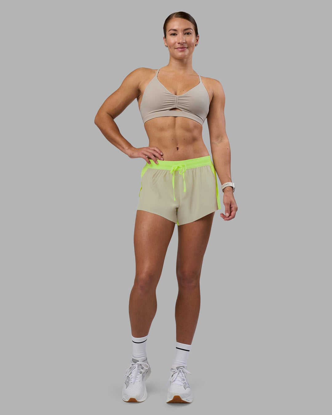 Woman wearing Accelerate 3&quot; Running Short - Lime Glo-Shale Beige | Model:Hannah | Size:S
