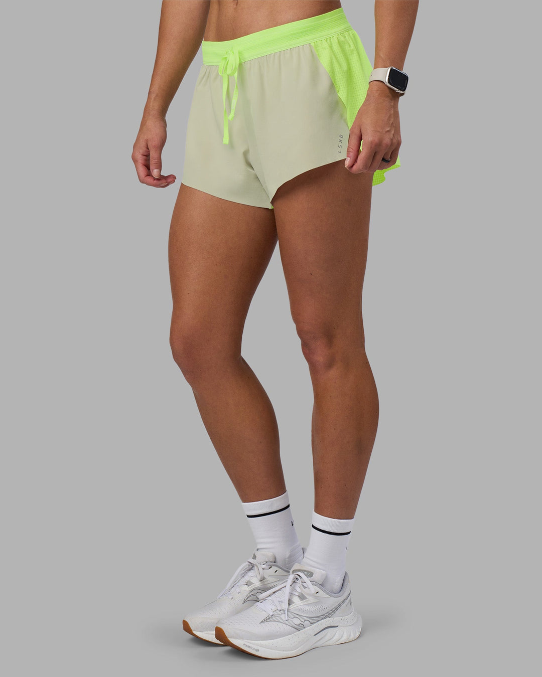 Woman wearing Accelerate 3&quot; Running Short - Lime Glo-Shale Beige | Model:Hannah | Size:S