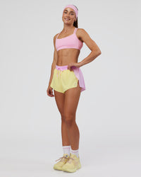 Woman wearing Accelerate 3" Mid-Rise Running Short - Marshmallow-Lemon | Model:Grace | Size:S