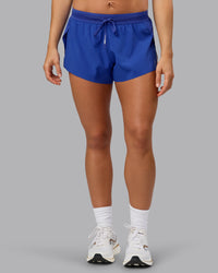 Woman wearing Accelerate 3" Run Short in Power Cobalt | Set:true | Angle:front | Model:Shalem | Size:S