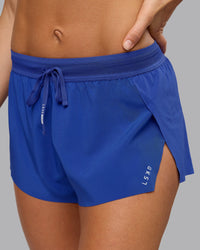 Woman wearing Accelerate 3" Run Short in Power Cobalt | Set:true | Angle:closeup | Model:Shalem | Size:S