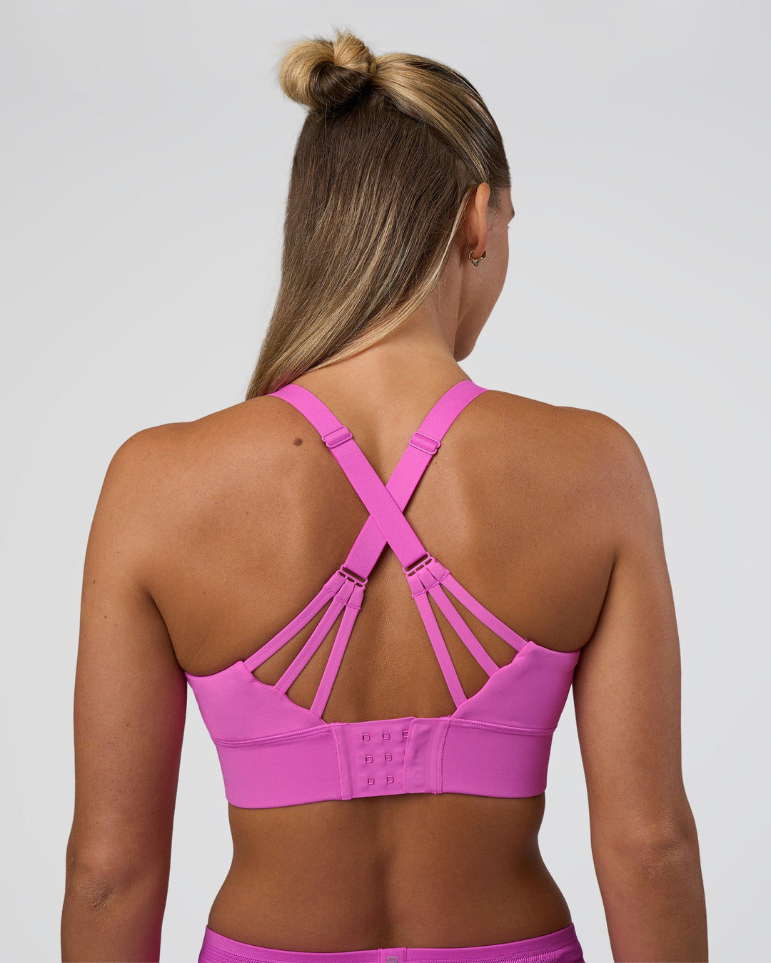 Woman wearing Accelerate Split Strap Sports Bra - Ultra Fuchsia | Model:Amity | Size:S