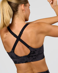 Woman wearing Accelerate Sports Bra - Black Tie Dye | Model:Amity | Size:S