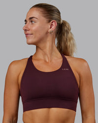 Woman wearing Accelerate Sports Bra - Cherry Lacquer | Set:true | Angle:front | Model:Hannah | Size:S