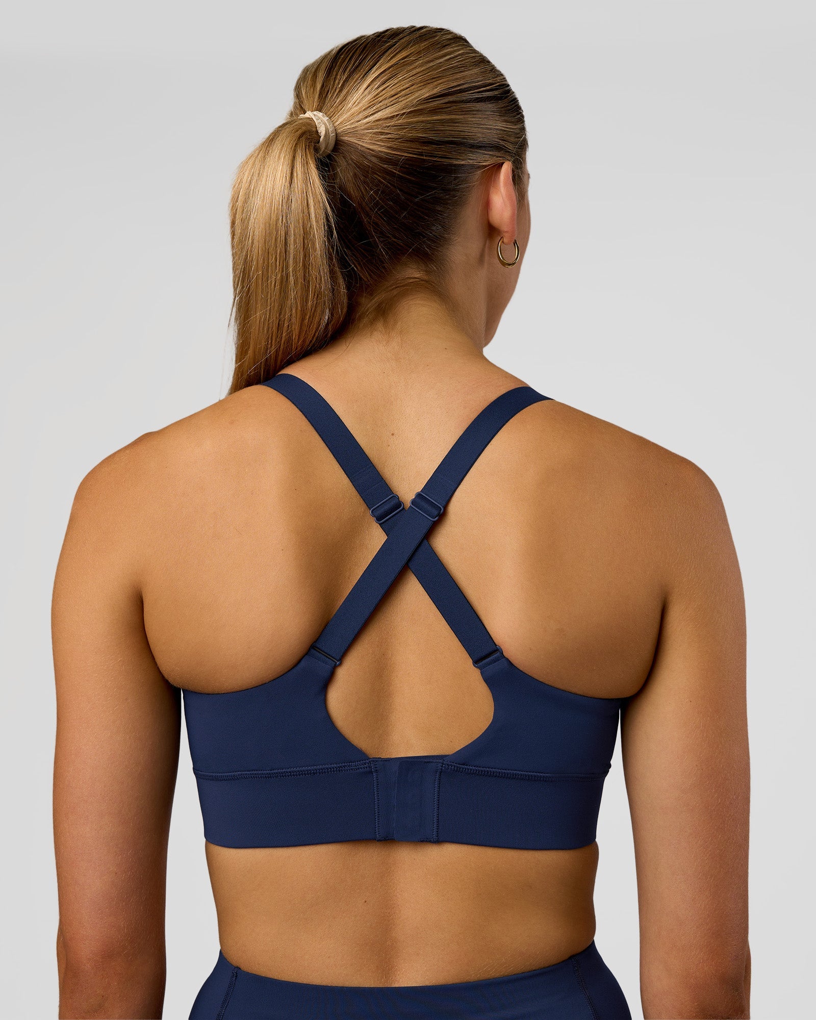 Woman wearing Accelerate Sports Bra - Future Navy | Model:Evie | Size:S