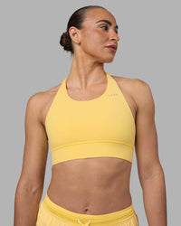 Woman wearing Accelerate Sports Bra - Lemon | Set:true | Angle:front | Model:Sophie | Size:S