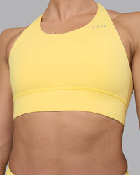 Woman wearing Accelerate Sports Bra - Lemon | Set:true | Angle:closeup | Model:Sophie | Size:S