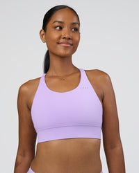 Woman wearing Accelerate Sports Bra - Pale Lilac | Set:true | Angle:front | Model:Rica | Size:S