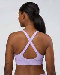 Woman wearing Accelerate Sports Bra - Pale Lilac | Set:true | Angle:back | Model:Rica | Size:S