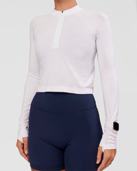 Woman wearing AeroFLX+ Long Sleeve Skimmer Half Zip - White/White | Model:Amity | Size:S