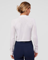 Woman wearing AeroFLX+ Long Sleeve Skimmer Half Zip - White/White | Model:Amity | Size:S