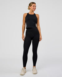 Woman wearing AeroFLX+ Seamless Flow Skimmer Tank - Black Marl | Model:Amity | Size:S