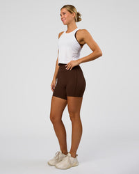 Woman wearing AeroFLX+ Seamless Flow Skimmer Tank - White/White | Model:Amity | Size:S | Thumbnail Index: 4