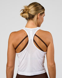 Woman wearing AeroFLX+ Seamless Flow Skimmer Tank - White/White | Model:Amity | Size:S | Thumbnail Index: 1