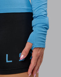 Woman wearing AeroFLX+ Seamless Long Sleeve Tee - Azure Blue Marl | Model:Halle | Size:S