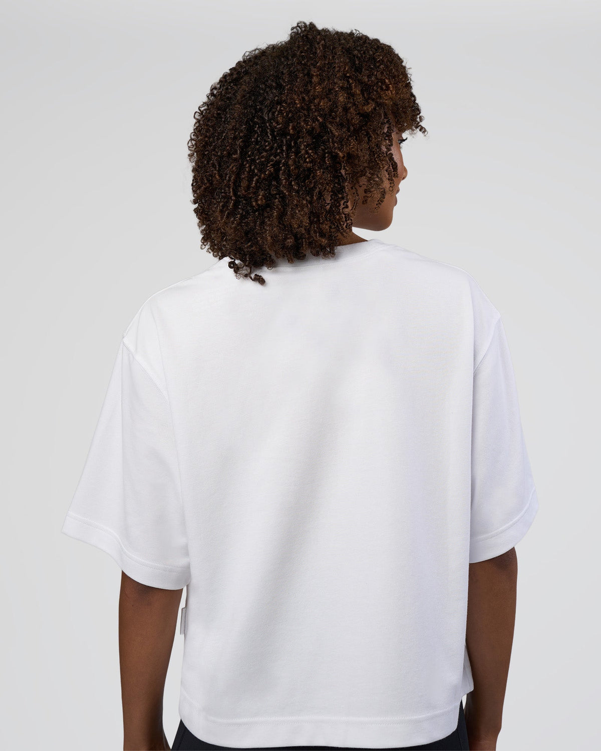Woman wearing AfterDark ZeroCrease Cropped Tee - White | Model:Tomi | Size:S - view 2