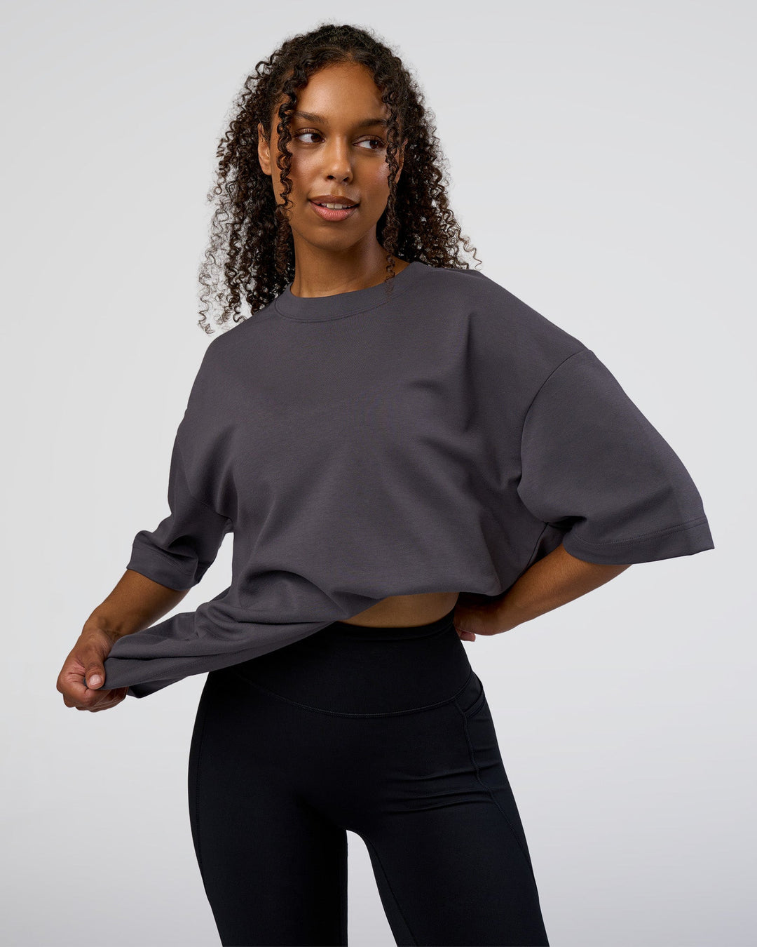 Woman wearing AfterDark ZeroCrease Oversized Tee - Dark Storm | Model:Jordan | Size:S