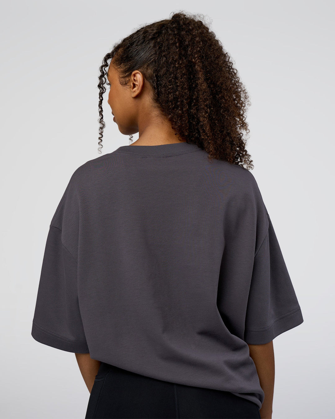 Woman wearing AfterDark ZeroCrease Oversized Tee - Dark Storm | Model:Jordan | Size:S