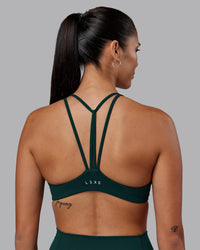 Woman wearing Agile Sports Bra - Dark Moss | Model:Rhiley | Size:S