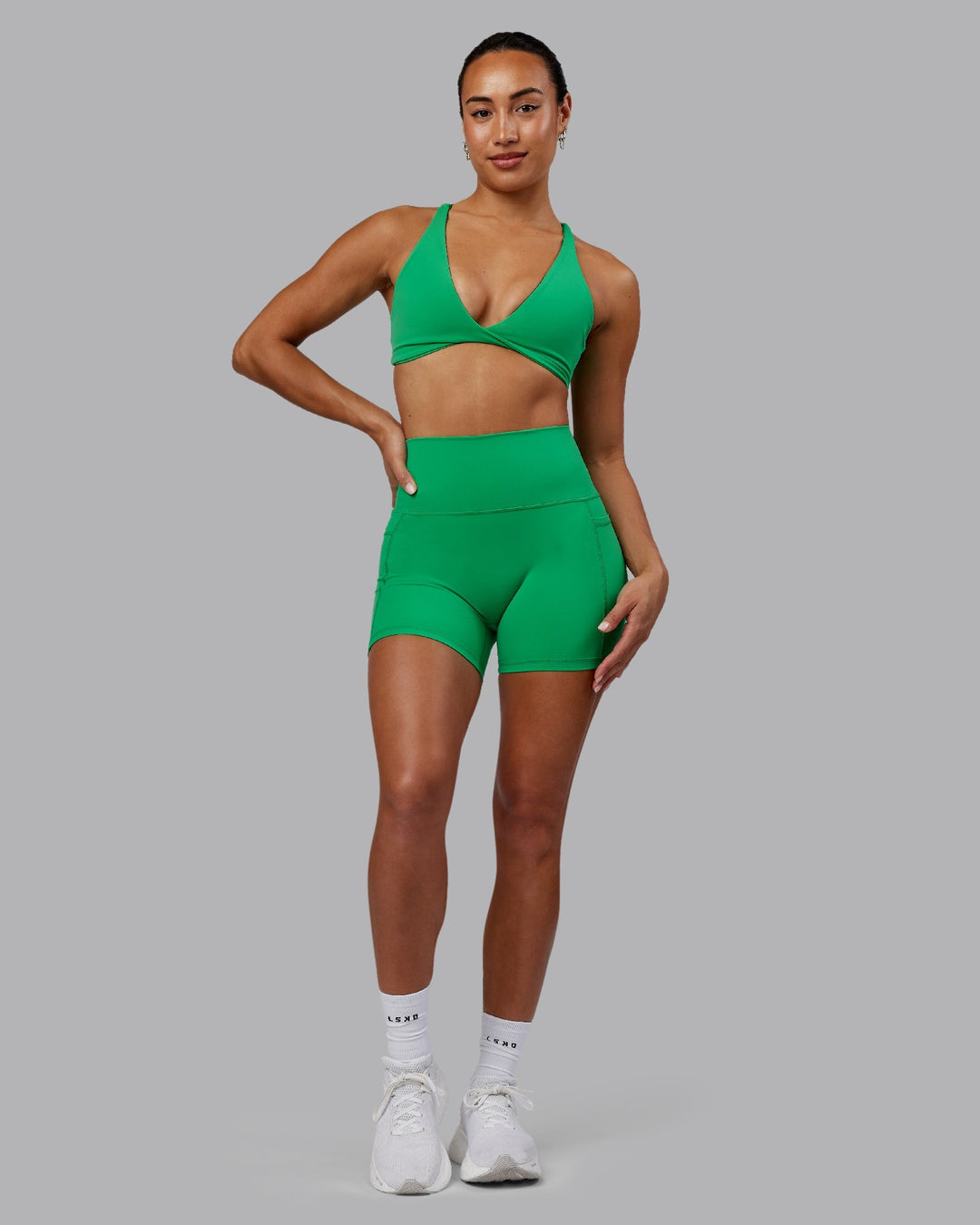 Woman wearing Agile Sports Bra - Impact Green