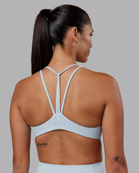 Woman wearing Agile Sports Bra - Skyride | Model:Rhiley | Size:S