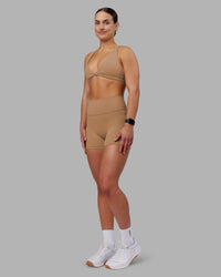 Woman wearing Agile Sports Bra - Warm Smoke | Model:Keisha | Size:S