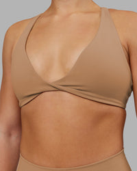 Woman wearing Agile Sports Bra - Warm Smoke | Model:Keisha | Size:S