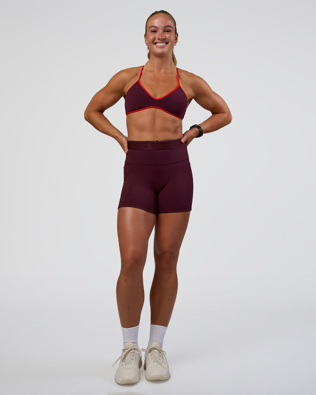 Woman wearing Ambience Sports Bra - Cherry Lacquer-Flame | Model:Sav | Size:S