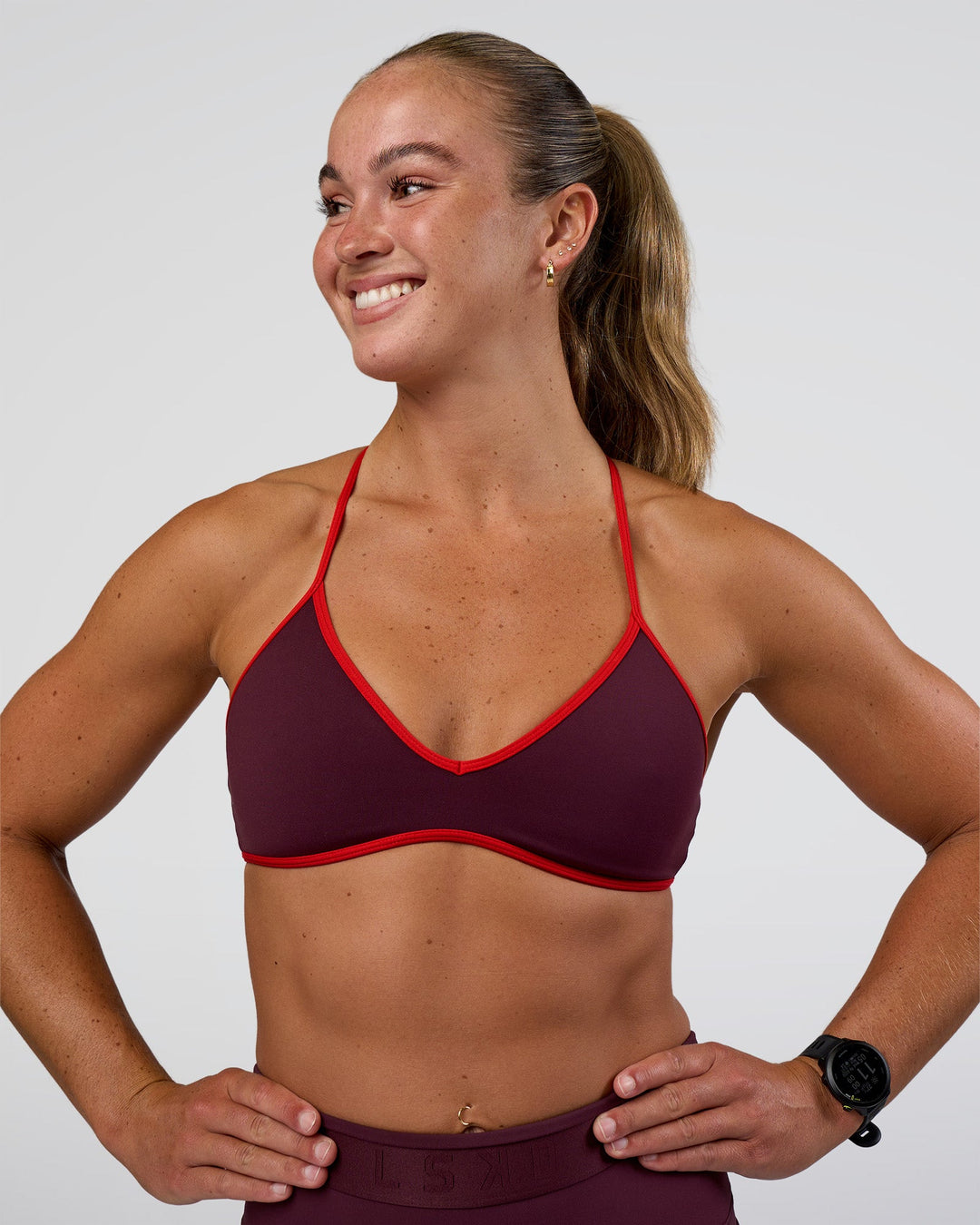 Woman wearing Ambience Sports Bra - Cherry Lacquer-Flame | Model:Sav | Size:S