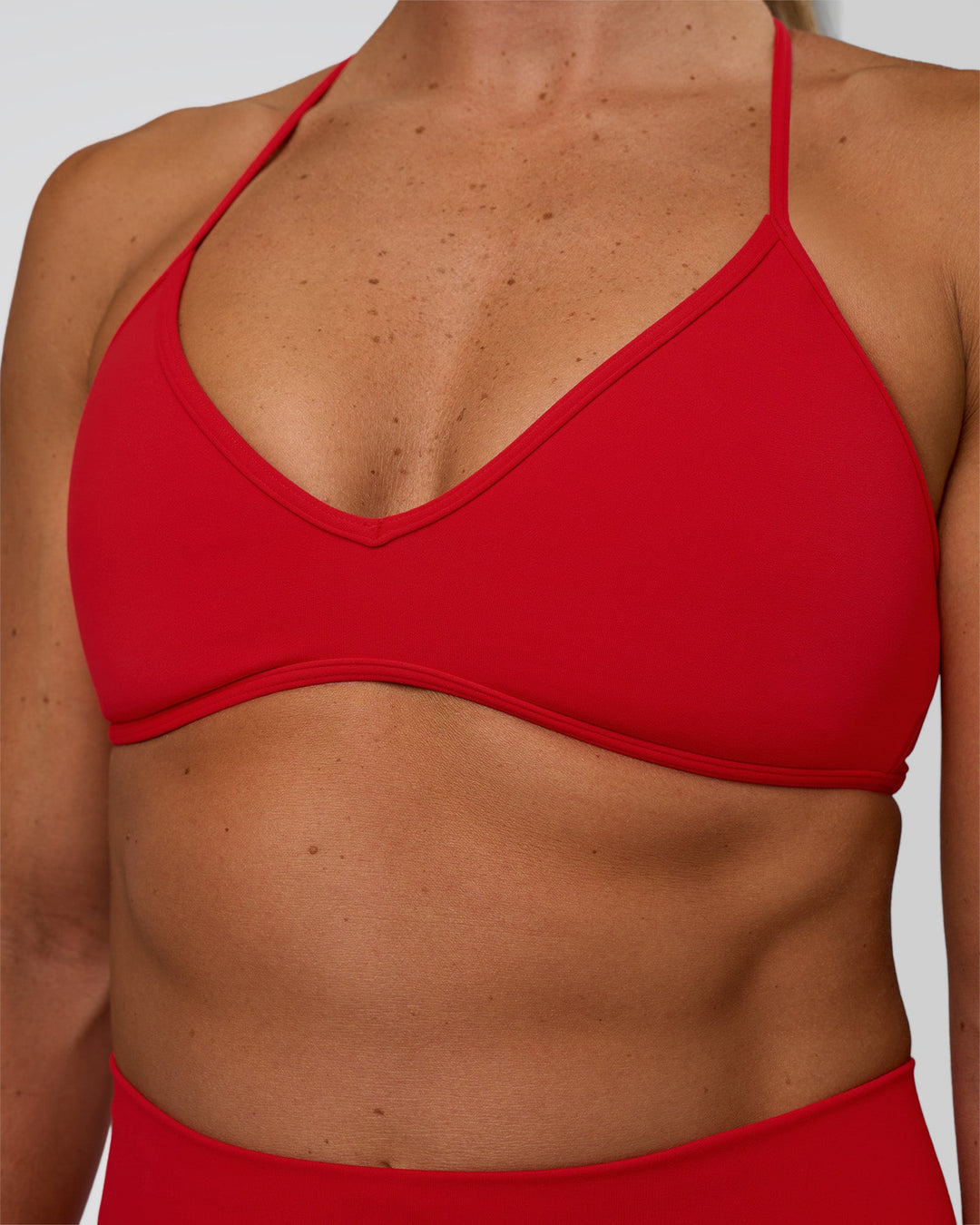 Woman wearing Ambience Sports Bra - Flame | Model:Sav | Size:S