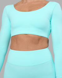 Woman wearing Aria Long Sleeve Sports Bra - Island Paradise | Model:Sophie | Size:S