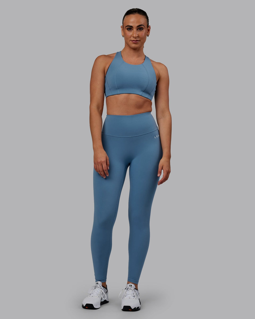 Woman wearing Ascent Sports Bra - Elemental Blue