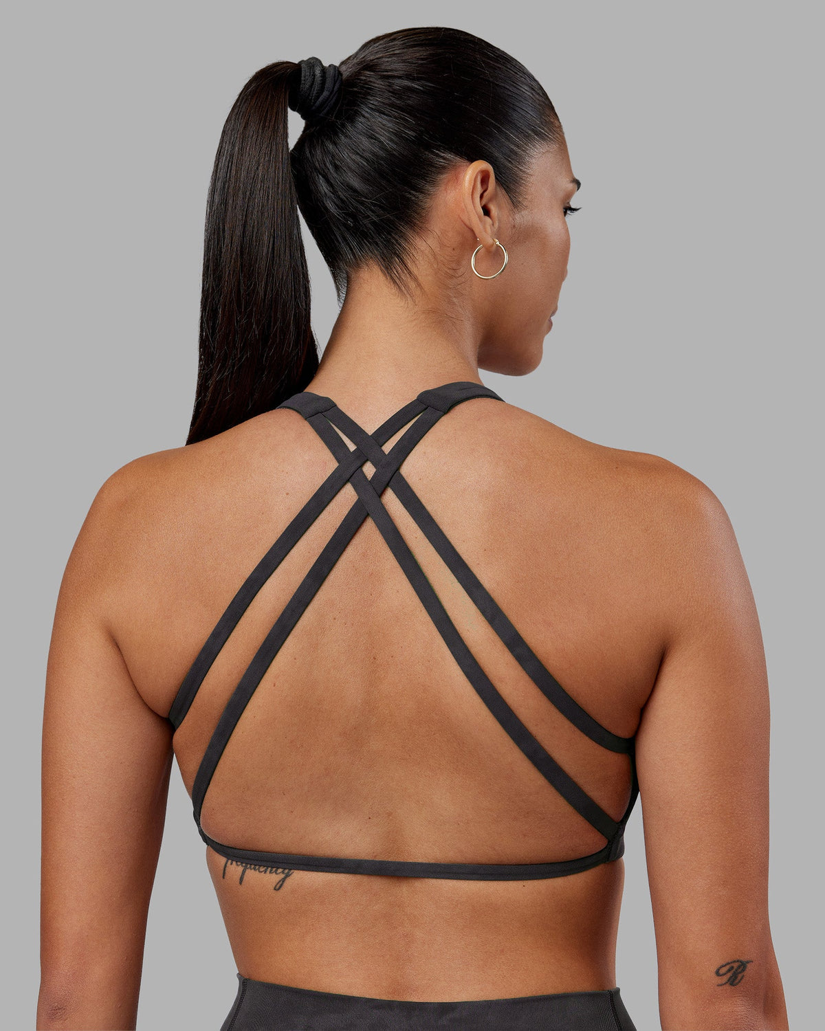 Woman wearing Aspire Sports Bra - Dark Storm Wash | Model:Rhiley | Size:S - view 1