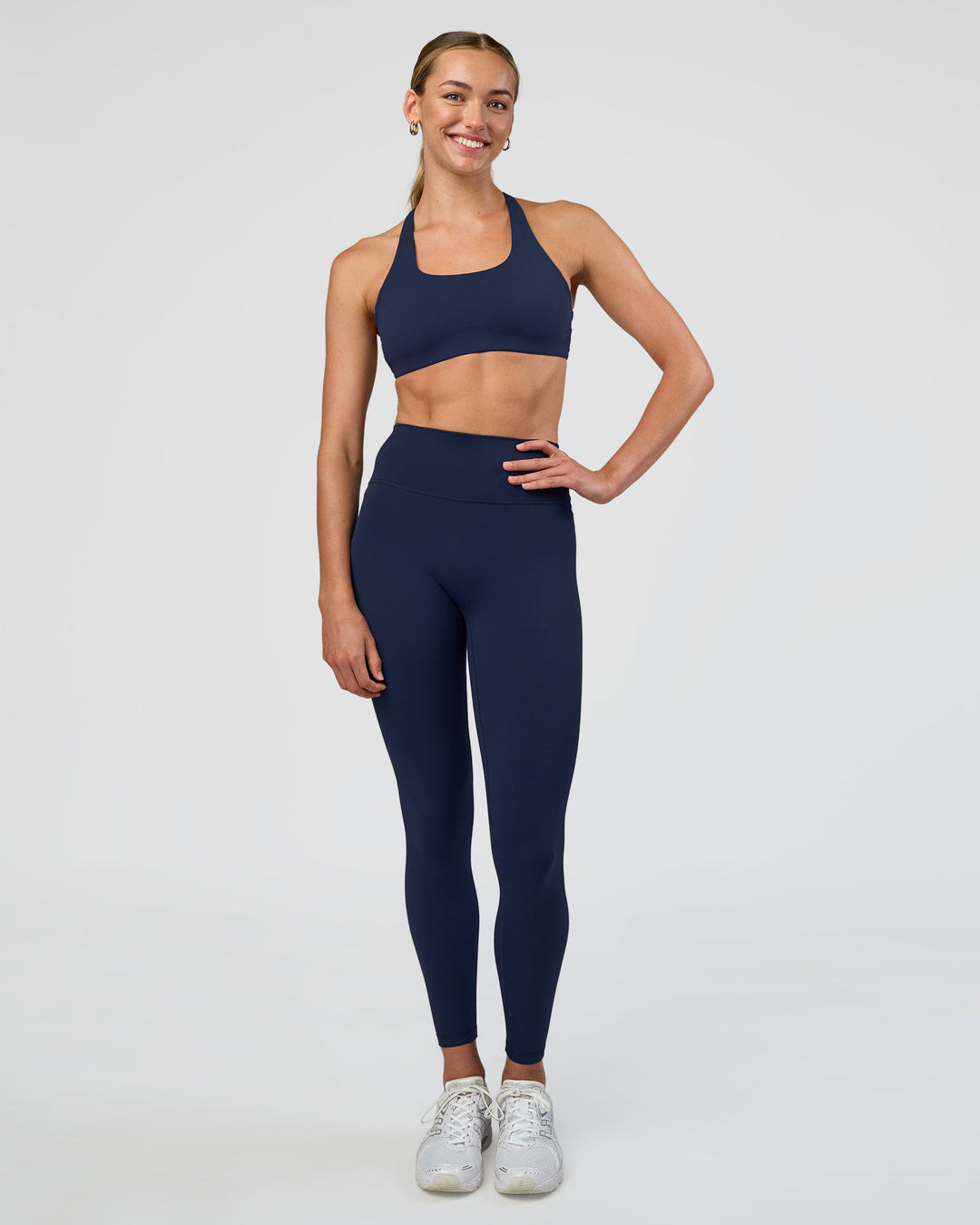 Woman wearing Aspire Sports Bra - Future Navy | Model:Evie | Size:S