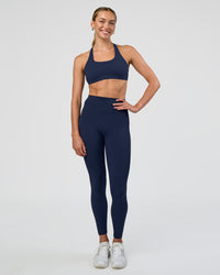 Woman wearing Aspire Sports Bra - Future Navy | Model:Evie | Size:S