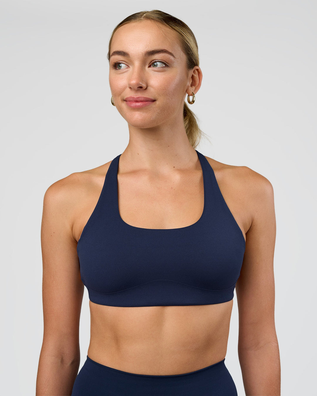 Woman wearing Aspire Sports Bra - Future Navy | Model:Evie | Size:S