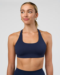 Woman wearing Aspire Sports Bra - Future Navy | Model:Evie | Size:S
